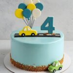 Green and blue cake with car and balloon toppers.