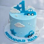 Blue sky cake with 3D car and cloud toppers.