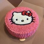 Pink Hello Kitty face shaped cream cake.