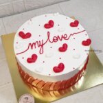 White cake with "my love" red text.