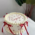 White cake with red ribbons decoration