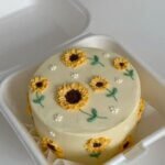 Yellow cake with hand-piped sunflowers.