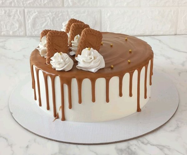 Lotus biscoff caramel drip cake white cream rosettes premium Karachi
