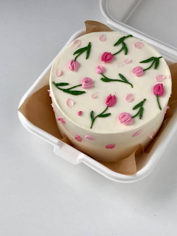 White bento cake pink tulip green leaves buttercream floral Karachi