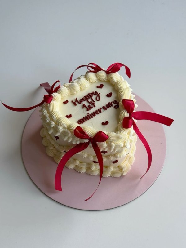 White heart anniversary cake red ribbon custom design Karachi